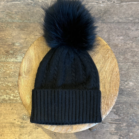 Cable knit hats with fur poms